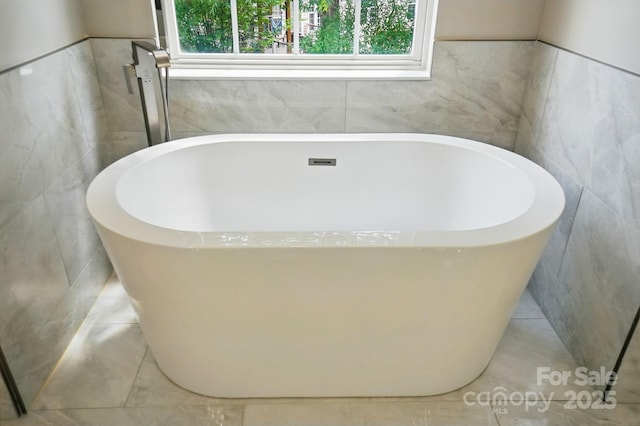 415 Glandon Ct, Fort Mill, SC 29708 - bathroom with tile walls and a freestanding bath