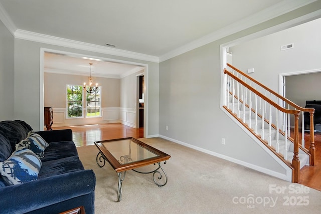 415 Glandon Ct, Fort Mill, SC 29708 - carpeted living area with a chandelier, stairway, ornamental molding, a wainscoted wall, and baseboards