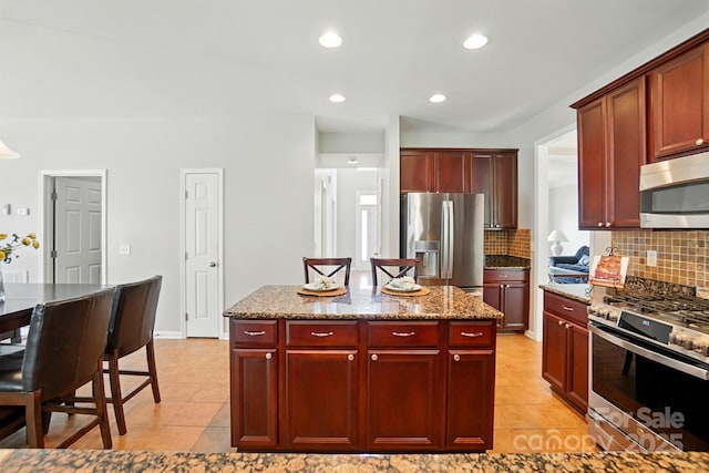415 Glandon Ct, Fort Mill, SC 29708 - kitchen with appliances with stainless steel finishes, dark brown cabinets, light tile patterned floors, backsplash, and recessed lighting