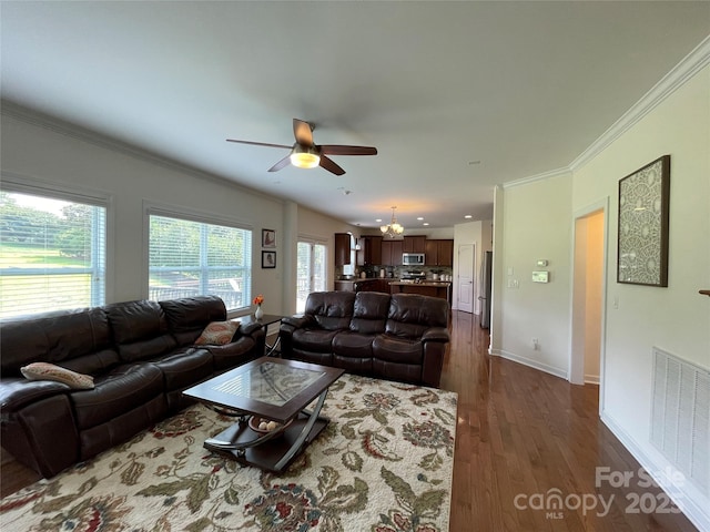 707 Five Leaf Ln, Waxhaw, NC 28173 - living room featuring ceiling fan, ornamental molding, dark wood-style flooring, baseboards, and a chandelier