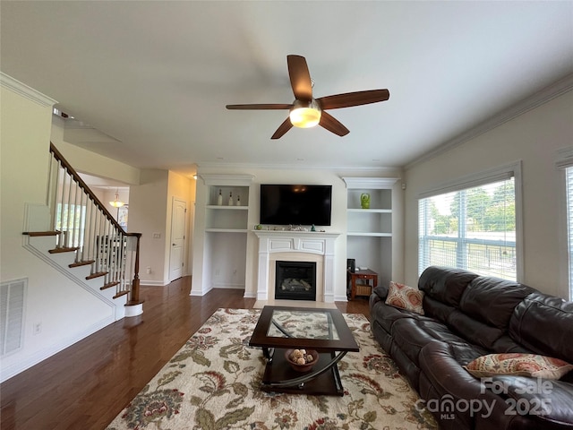 707 Five Leaf Ln, Waxhaw, NC 28173 - living area featuring wood finished floors, ceiling fan, stairs, a fireplace with flush hearth, and built in shelves
