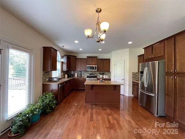 707 Five Leaf Ln, Waxhaw, NC 28173 - kitchen featuring stainless steel appliances, a chandelier, a sink, dark wood-type flooring, and a center island
