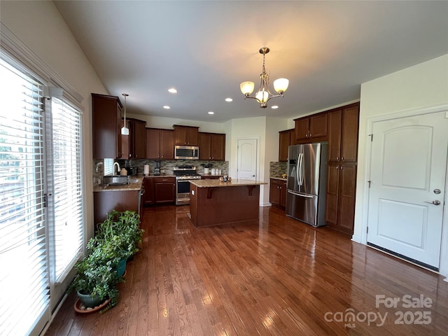707 Five Leaf Ln, Waxhaw, NC 28173 - kitchen with appliances with stainless steel finishes, plenty of natural light, a chandelier, a kitchen island, and recessed lighting