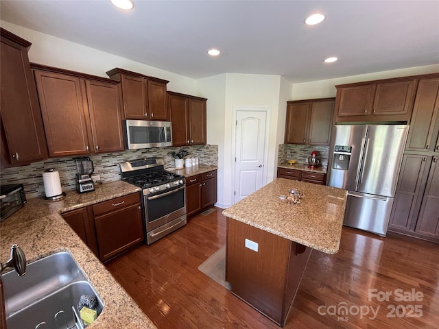 707 Five Leaf Ln, Waxhaw, NC 28173 - kitchen with appliances with stainless steel finishes, a sink, a kitchen island, light stone countertops, and recessed lighting