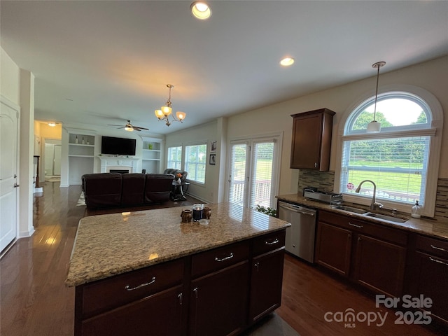 707 Five Leaf Ln, Waxhaw, NC 28173 - kitchen with a sink, dishwasher, a fireplace, dark wood finished floors, and decorative light fixtures