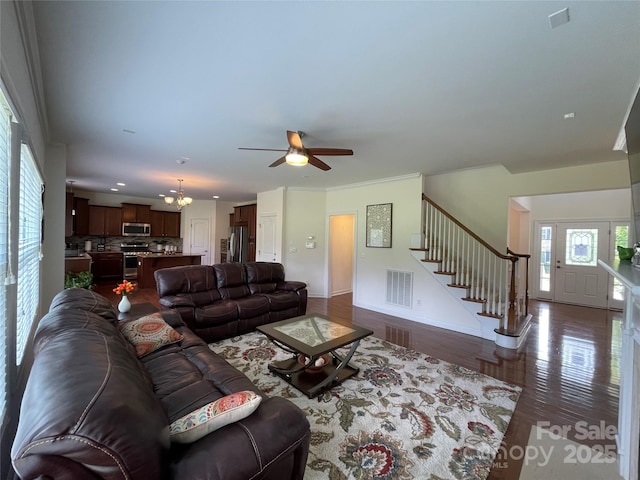 707 Five Leaf Ln, Waxhaw, NC 28173 - living area featuring stairway, ceiling fan, a chandelier, dark wood-style flooring, and baseboards