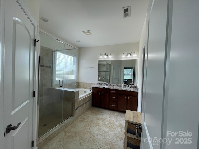 707 Five Leaf Ln, Waxhaw, NC 28173 - bathroom with double vanity, a bath, a stall shower, and plenty of natural light