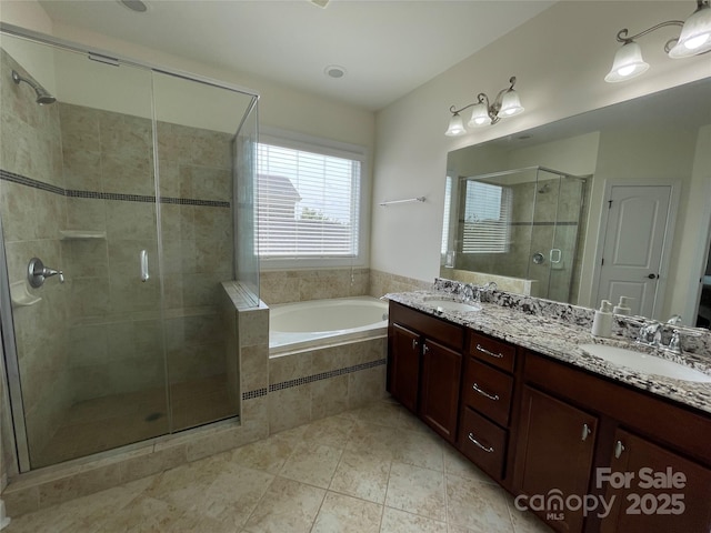 707 Five Leaf Ln, Waxhaw, NC 28173 - full bathroom featuring a garden tub, a shower stall, double vanity, and tile patterned flooring
