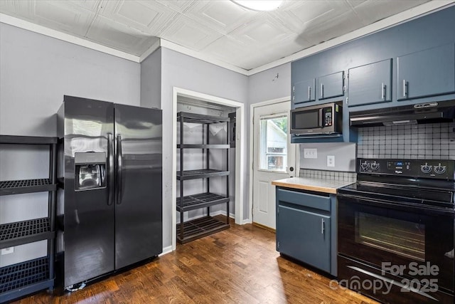 935 Church St, Kings Mountain, NC 28086 - kitchen with appliances with stainless steel finishes, under cabinet range hood, an ornate ceiling, tasteful backsplash, and blue cabinets