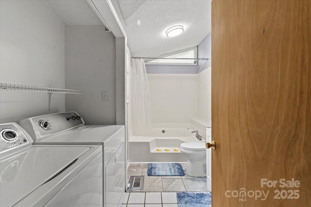 935 Church St, Kings Mountain, NC 28086 - laundry area featuring washing machine and dryer, a textured ceiling, and tile patterned floors