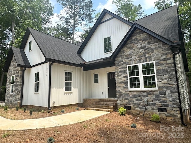 248 Pioneer Dr, Mount Gilead, NC 27306 - view of front of home with stone siding, a shingled roof, and crawl space