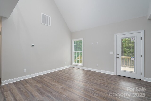 248 Pioneer Dr, Mount Gilead, NC 27306 - unfurnished living room with dark wood-style floors and high vaulted ceiling
