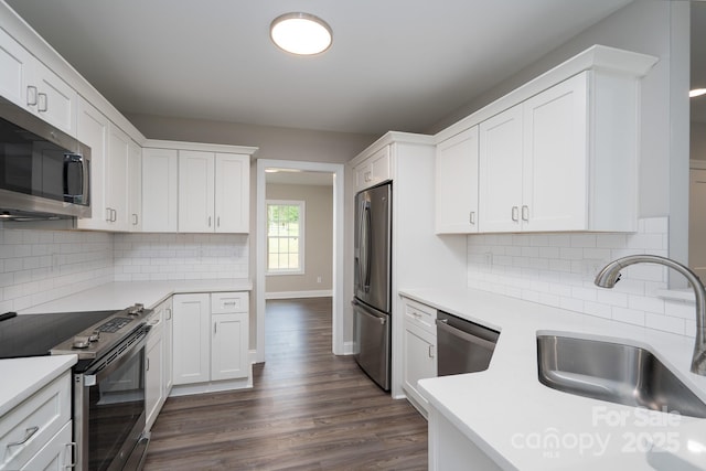 248 Pioneer Dr, Mount Gilead, NC 27306 - kitchen with appliances with stainless steel finishes, light countertops, dark wood-style flooring, and white cabinets