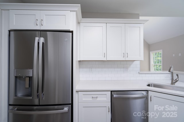 248 Pioneer Dr, Mount Gilead, NC 27306 - kitchen with stainless steel appliances, tasteful backsplash, light countertops, white cabinetry, and vaulted ceiling