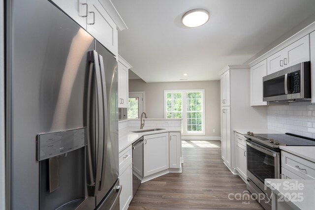 248 Pioneer Dr, Mount Gilead, NC 27306 - kitchen with stainless steel appliances, light countertops, white cabinetry, dark wood finished floors, and recessed lighting