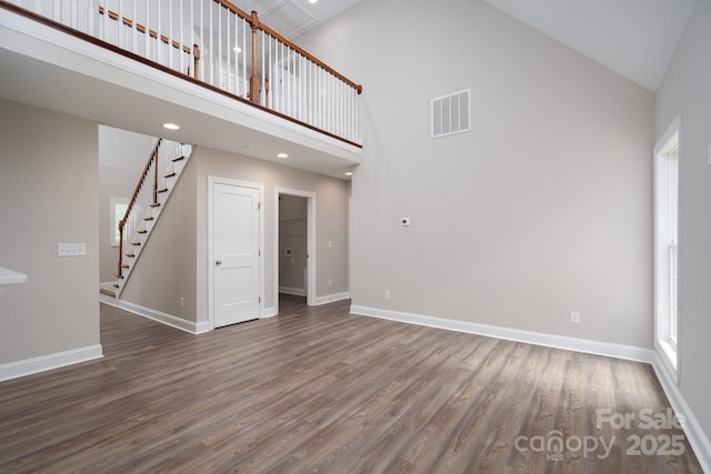 248 Pioneer Dr, Mount Gilead, NC 27306 - unfurnished living room with high vaulted ceiling, wood finished floors, and stairs