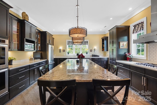 2354 Valelake Rd, York, SC 29745 - kitchen with stainless steel appliances, crown molding, a breakfast bar area, healthy amount of natural light, and light wood finished floors