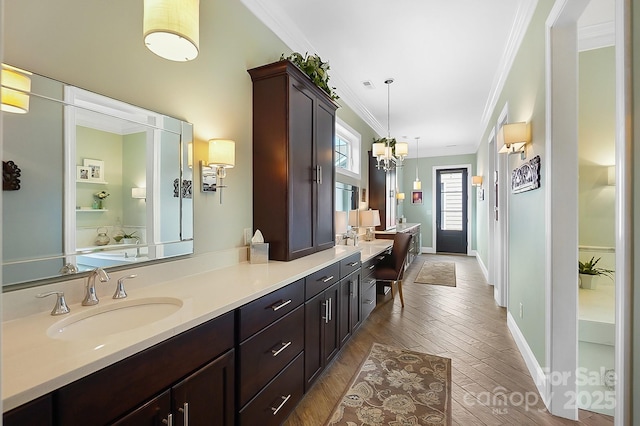 2354 Valelake Rd, York, SC 29745 - full bath featuring crown molding, double vanity, wood finished floors, a chandelier, and baseboards