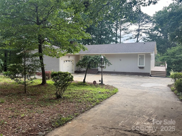 18 Olde Duffers Dr, Nebo, NC 28761 - view of front facade featuring driveway, a garage, a wooden deck, and roof with shingles