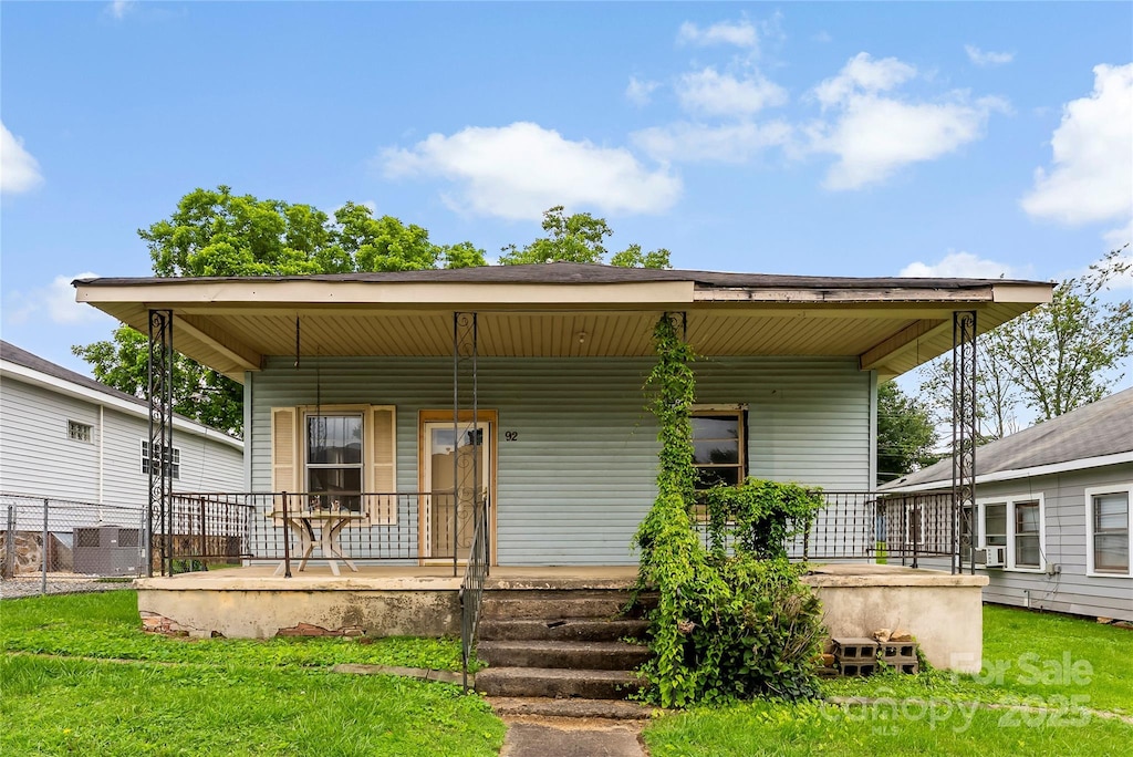 92 E Spencer Mountain Ave, Gastonia, NC 28054 - view of front of house featuring covered porch, a front yard, and central AC unit