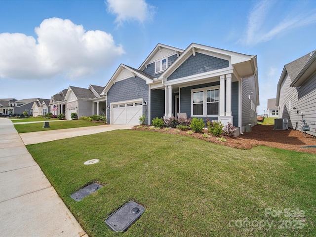 6015 Waldorf Ave, Monroe, NC 28110 - craftsman-style house with central AC unit, concrete driveway, a front yard, covered porch, and a garage