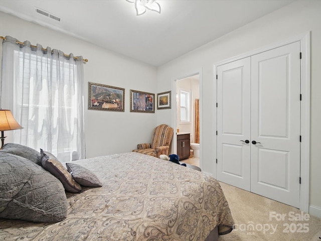 6015 Waldorf Ave, Monroe, NC 28110 - bedroom featuring light carpet, a closet, and ensuite bath