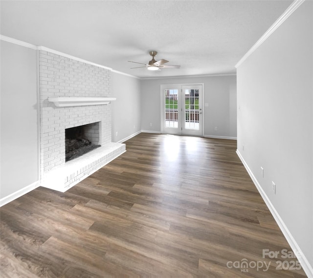 124 Creek Hollow Trl, Belmont, NC 28012 - unfurnished living room with ceiling fan, crown molding, a brick fireplace, baseboards, and dark wood-type flooring