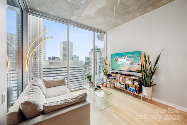 210 N Church St Unit 2807, Charlotte, NC 28202 - living area featuring expansive windows, healthy amount of natural light, and wood finished floors