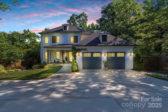 4211 Tangle Dr, Charlotte, NC 28211 - view of front facade featuring covered porch, concrete driveway, an attached garage, roof with shingles, and stucco siding