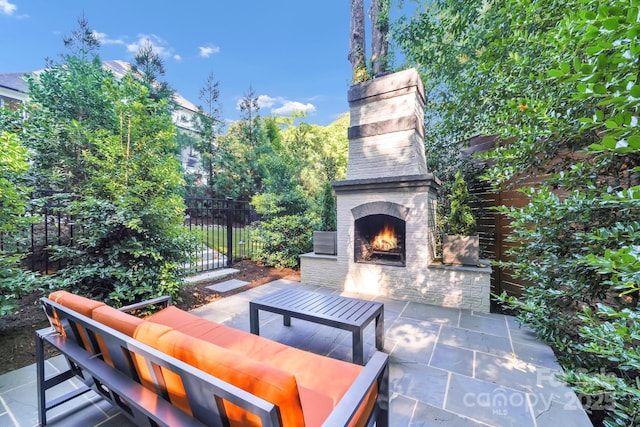 4211 Tangle Dr, Charlotte, NC 28211 - view of patio with an outdoor living space with a fireplace
