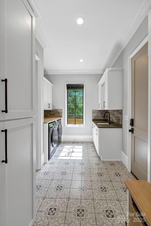 4211 Tangle Dr, Charlotte, NC 28211 - laundry room featuring baseboards, recessed lighting, cabinet space, and light tile patterned floors