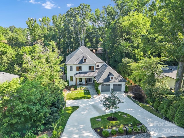 4211 Tangle Dr, Charlotte, NC 28211 - view of front of home with a garage, driveway, a standing seam roof, metal roof, and roof with shingles