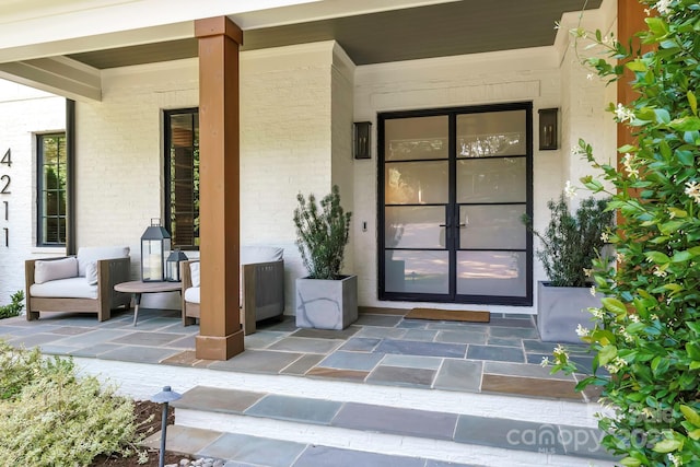4211 Tangle Dr, Charlotte, NC 28211 - doorway to property featuring brick siding and a porch