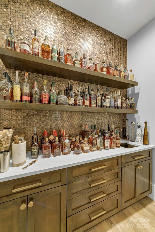 4211 Tangle Dr, Charlotte, NC 28211 - indoor dry bar featuring light wood-style floors and decorative backsplash