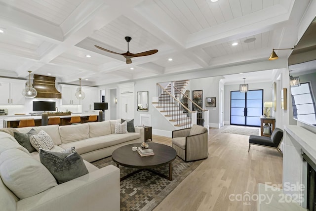 4211 Tangle Dr, Charlotte, NC 28211 - living room featuring stairway, light wood-type flooring, beamed ceiling, baseboards, and coffered ceiling