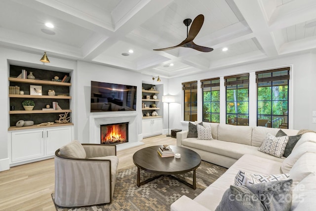 4211 Tangle Dr, Charlotte, NC 28211 - living room with light wood finished floors, a ceiling fan, a premium fireplace, built in features, and beamed ceiling