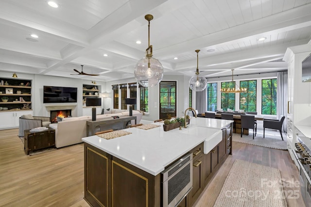 4211 Tangle Dr, Charlotte, NC 28211 - kitchen with a sink, stainless steel appliances, light wood-type flooring, an island with sink, and recessed lighting