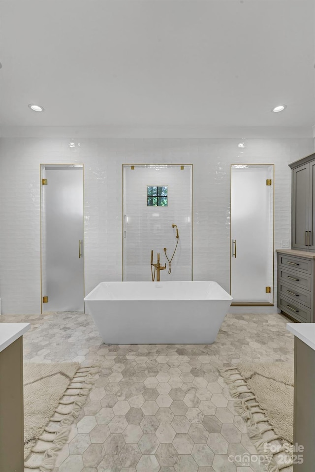 4211 Tangle Dr, Charlotte, NC 28211 - bathroom featuring vanity, a soaking tub, and recessed lighting