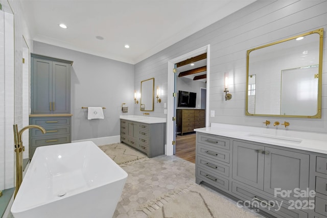 4211 Tangle Dr, Charlotte, NC 28211 - bathroom with two vanities, a freestanding tub, baseboards, crown molding, and recessed lighting