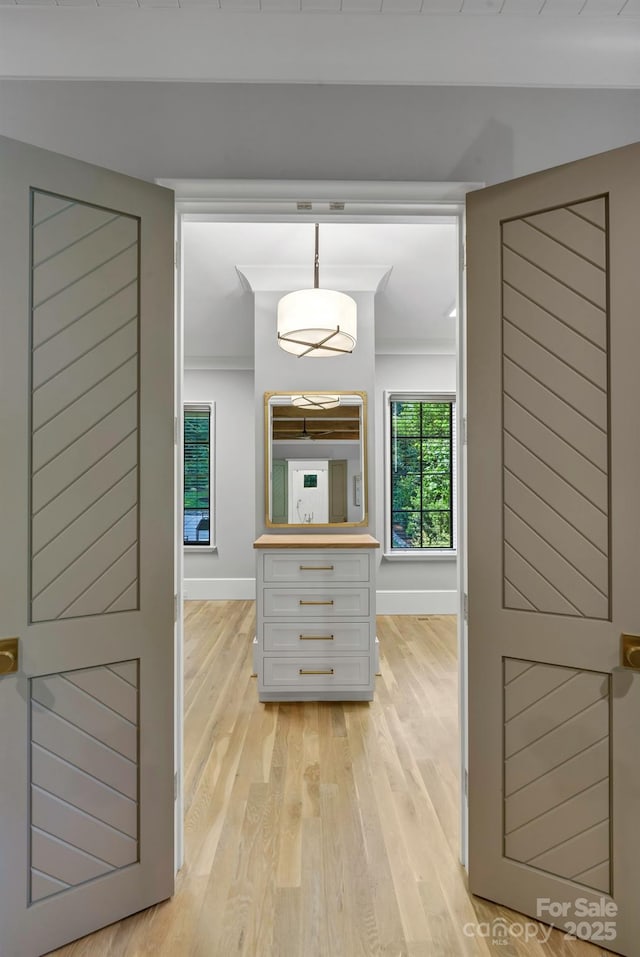 4211 Tangle Dr, Charlotte, NC 28211 - hallway with light wood-type flooring, baseboards, and ornamental molding