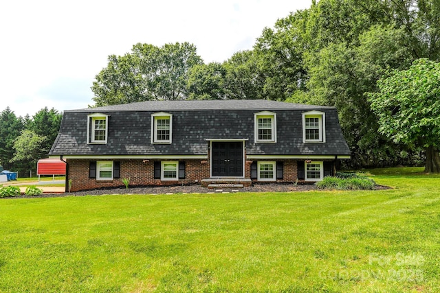 1867 Shannon Dr, Conover, NC 28613 - bi-level home featuring a shingled roof, a front yard, brick siding, mansard roof, and view of scattered trees