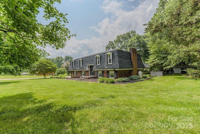 1867 Shannon Dr, Conover, NC 28613 - rear view of property featuring mansard roof, a lawn, brick siding, and a chimney