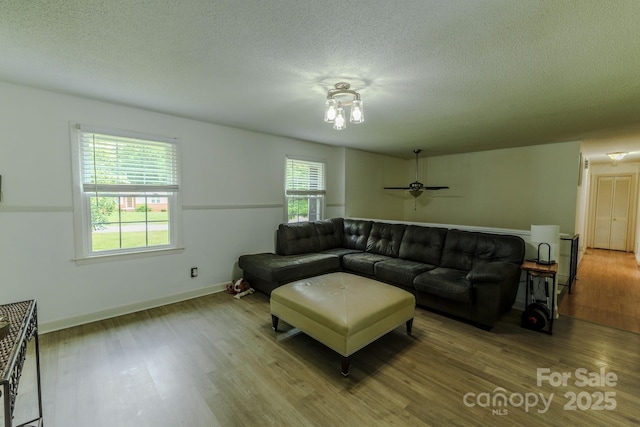 1867 Shannon Dr, Conover, NC 28613 - living room featuring wood finished floors, a textured ceiling, a ceiling fan, and baseboards