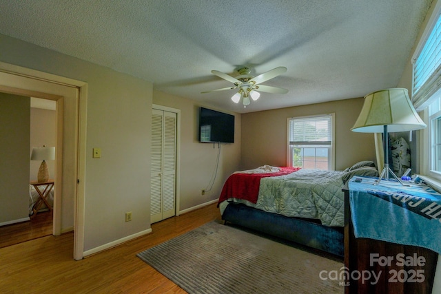 1867 Shannon Dr, Conover, NC 28613 - bedroom with baseboards, wood finished floors, a textured ceiling, a closet, and a ceiling fan