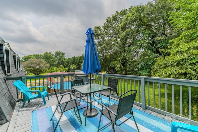 1867 Shannon Dr, Conover, NC 28613 - deck with outdoor dining area, a yard, and view of wooded area