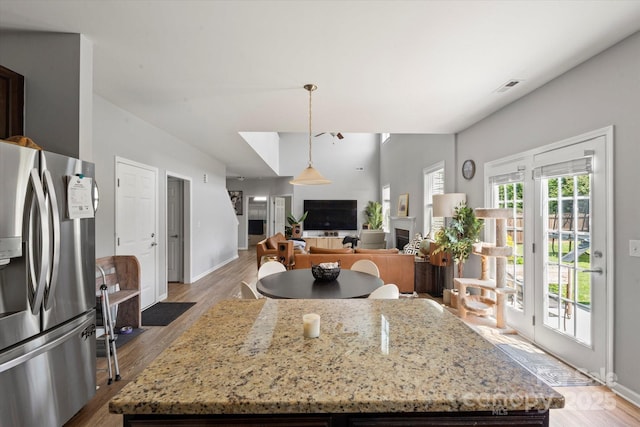 197 Roanoke Rd, Fletcher, NC 28732 - kitchen with stainless steel fridge, light wood-style floors, hanging light fixtures, and a center island