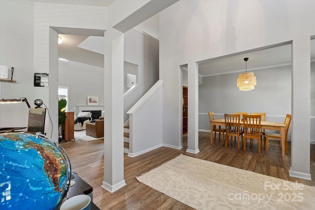 197 Roanoke Rd, Fletcher, NC 28732 - dining room with wood finished floors, stairway, a high ceiling, baseboards, and a fireplace