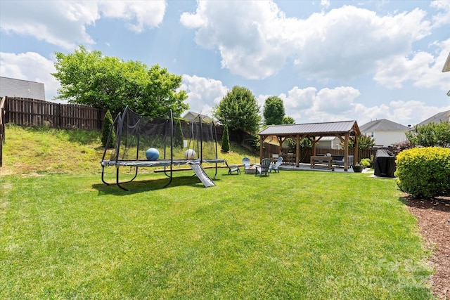 197 Roanoke Rd, Fletcher, NC 28732 - view of yard featuring a trampoline, a gazebo, a patio area, and an outdoor fire pit