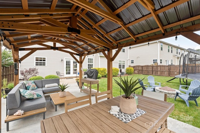 197 Roanoke Rd, Fletcher, NC 28732 - wooden terrace with a patio area, a trampoline, an outdoor hangout area, french doors, and outdoor dining space