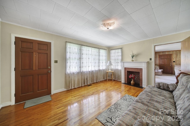 2084 Old Evans Cir, Lancaster, SC 29720 - living area featuring wood finished floors, ornamental molding, a brick fireplace, and baseboards